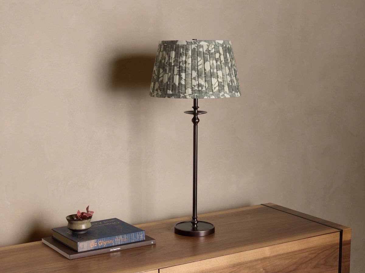 Front view of a Bronze Winslow Table Lamp, featuring a green and white floral pleated fabric shade.