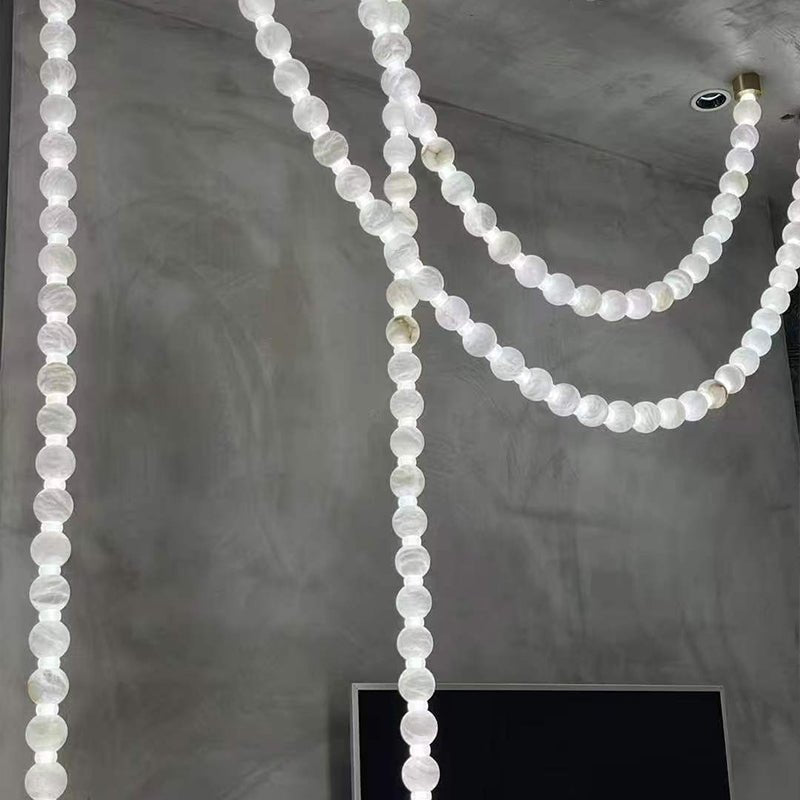 https://cdn.shopify.com/s/files/1/0736/8795/7790/files/alabaster-pearl-necklace-chandelier-1776475.jpg?v=1773801533