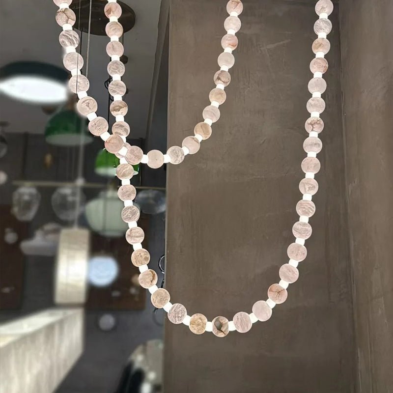 https://cdn.shopify.com/s/files/1/0736/8795/7790/files/alabaster-pearl-necklace-chandelier-3815981.jpg?v=1773801533