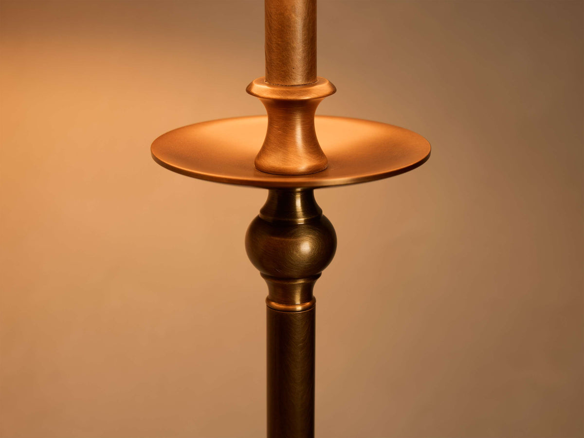 Close-up of the antique bronze Winslow Table Lamp's stem, featuring a circular disc and a spherical accent.