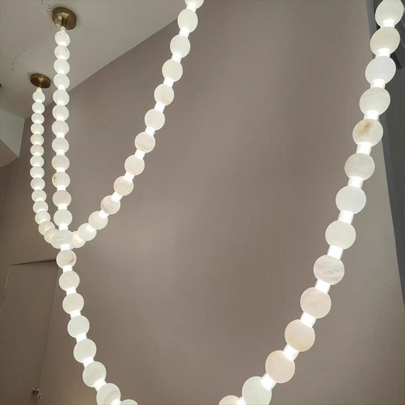 https://cdn.shopify.com/s/files/1/0736/8795/7790/files/alabaster-pearl-necklace-chandelier-5228342.jpg?v=1773801533
