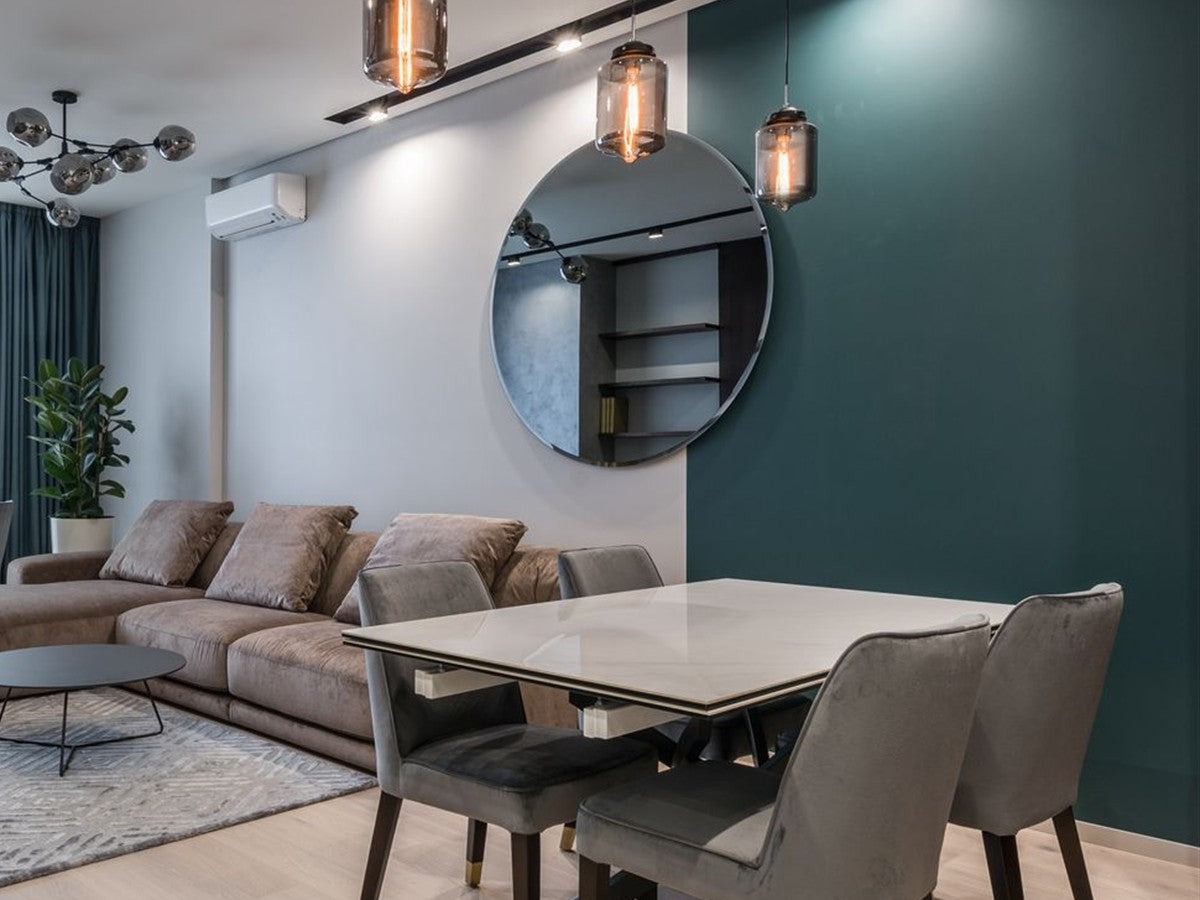 Contemporary residential dining area with glass pendant lights