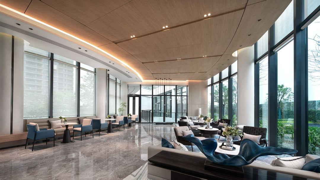 Modern hotel lounge with a slatted wood ceiling and floor-to-ceiling windows